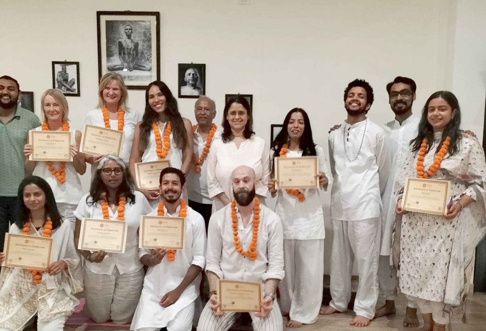 Graduates of the Light House Yoga Teacher Training holding certificates
